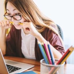 woman anxiously chewing on pencil
