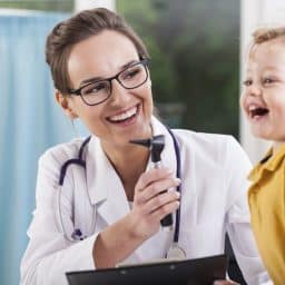 Young smiling child and an audiologist