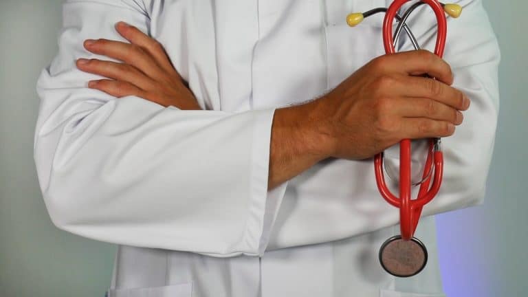 Doctor crossing shoulders and holding a stethoscope.