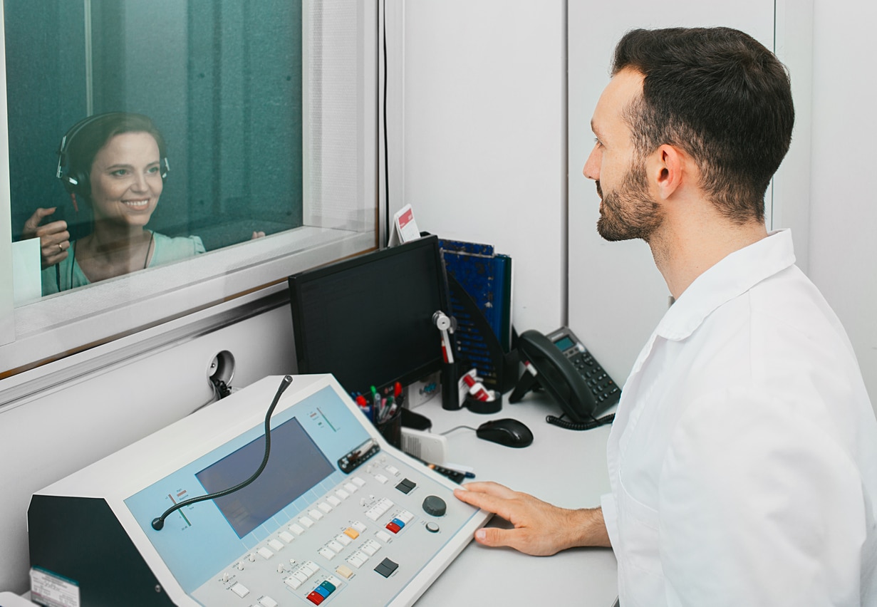 Audiologist administering a hearing test