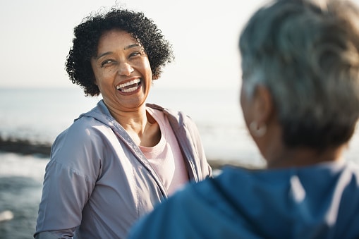Happy, confident woman smiling with her friends on the beach.